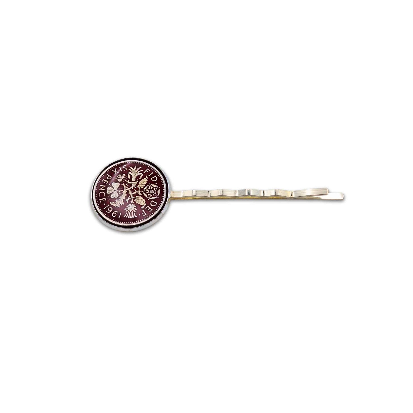 Silver plated hair slide with enamelled red sixpence coin design on a white background