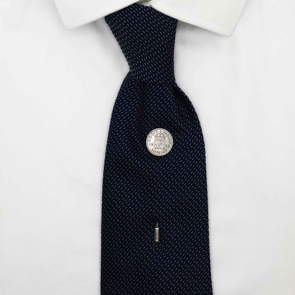 Navy tie on white shirt with King George 6th coin tie pin