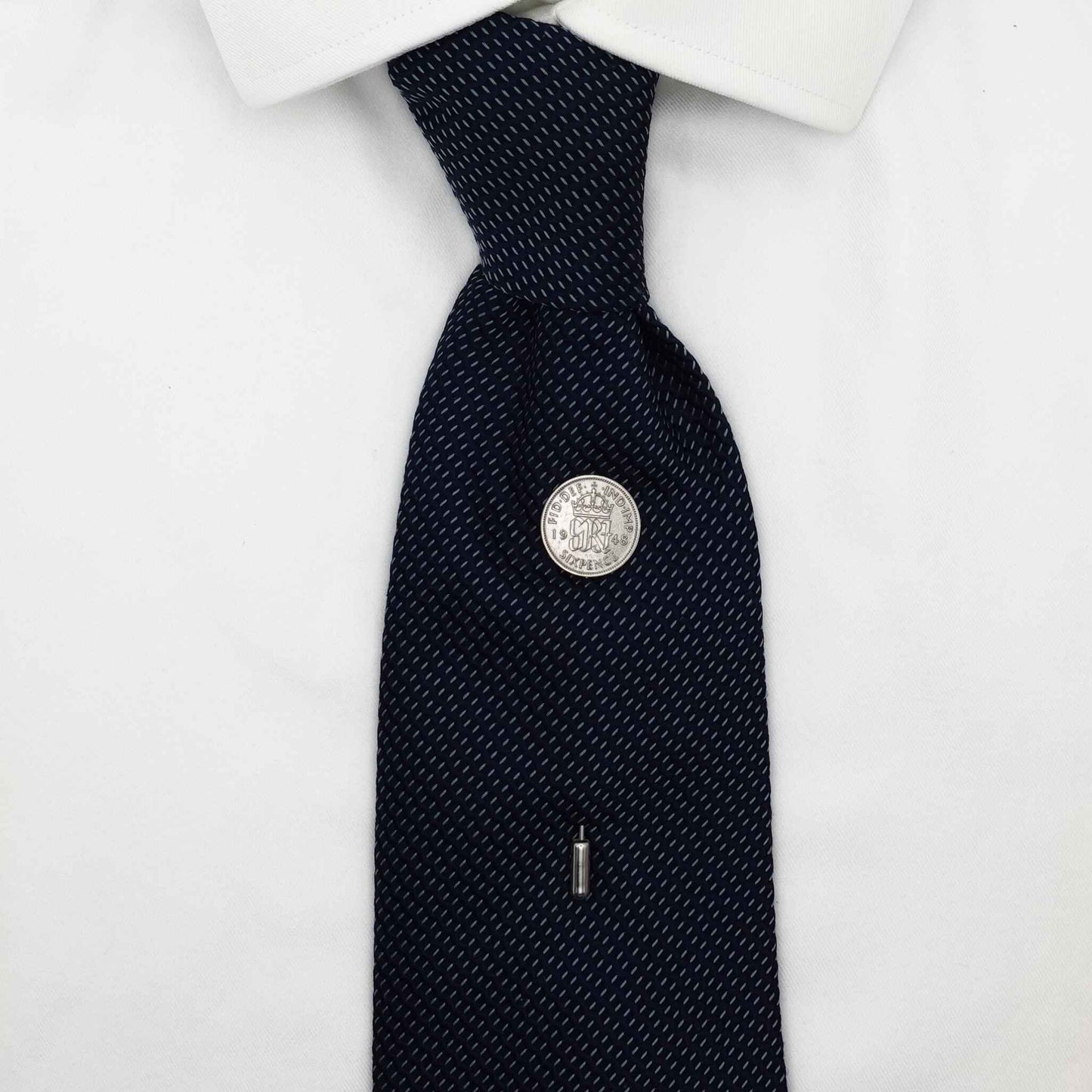 Navy tie on white shirt with King George 6th coin tie pin