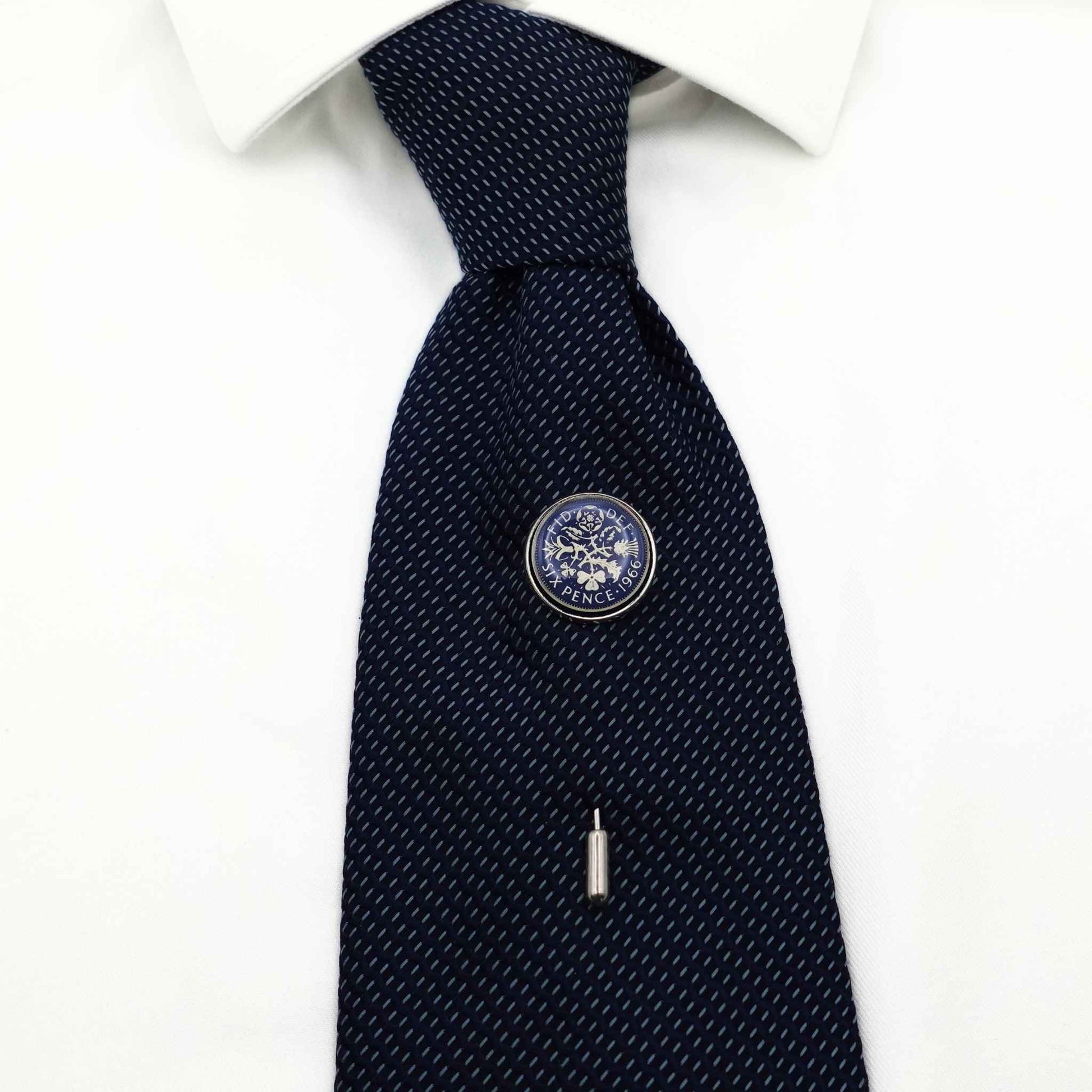 British sixpence coin blue enamel silver plated tie pin on navy tie, white shirt in background