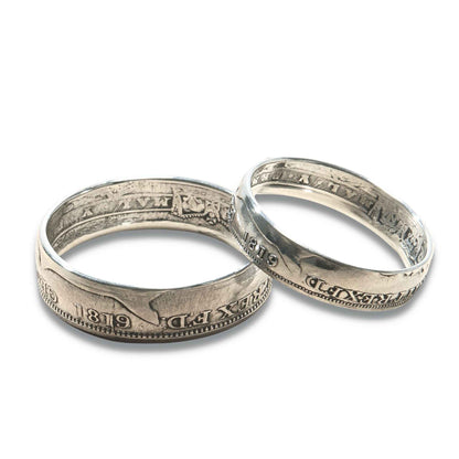 Two silver 1819 coin rings on a white background