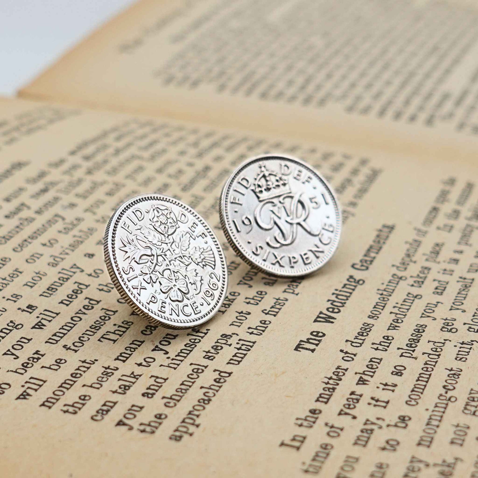 Two british sixpence coin lapel pins showing Queen Elizabeth 2nd and King George 6th minting designs