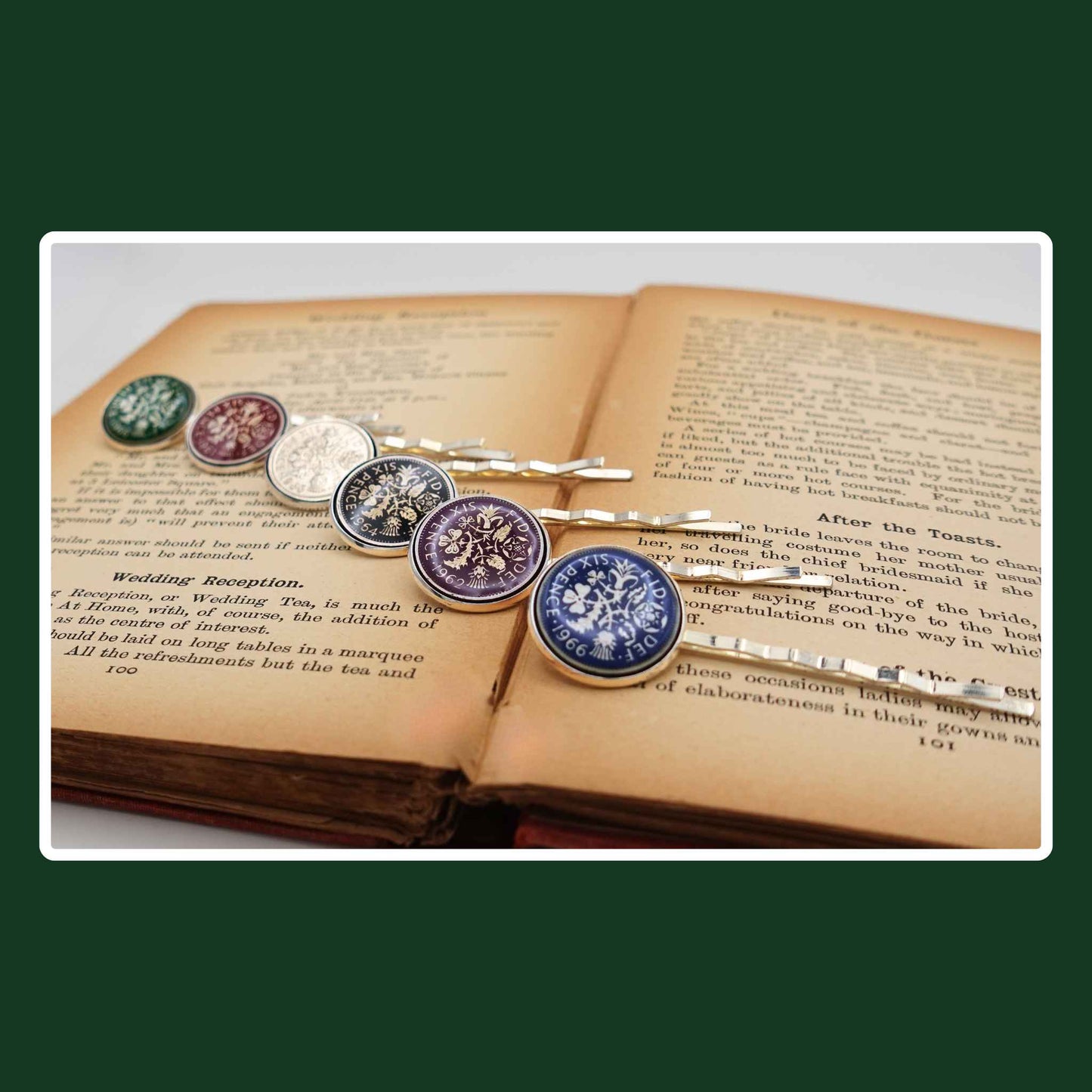 Set of British Queen Elizabeth 2nd sixpence coin enamelled hair slides on an open book