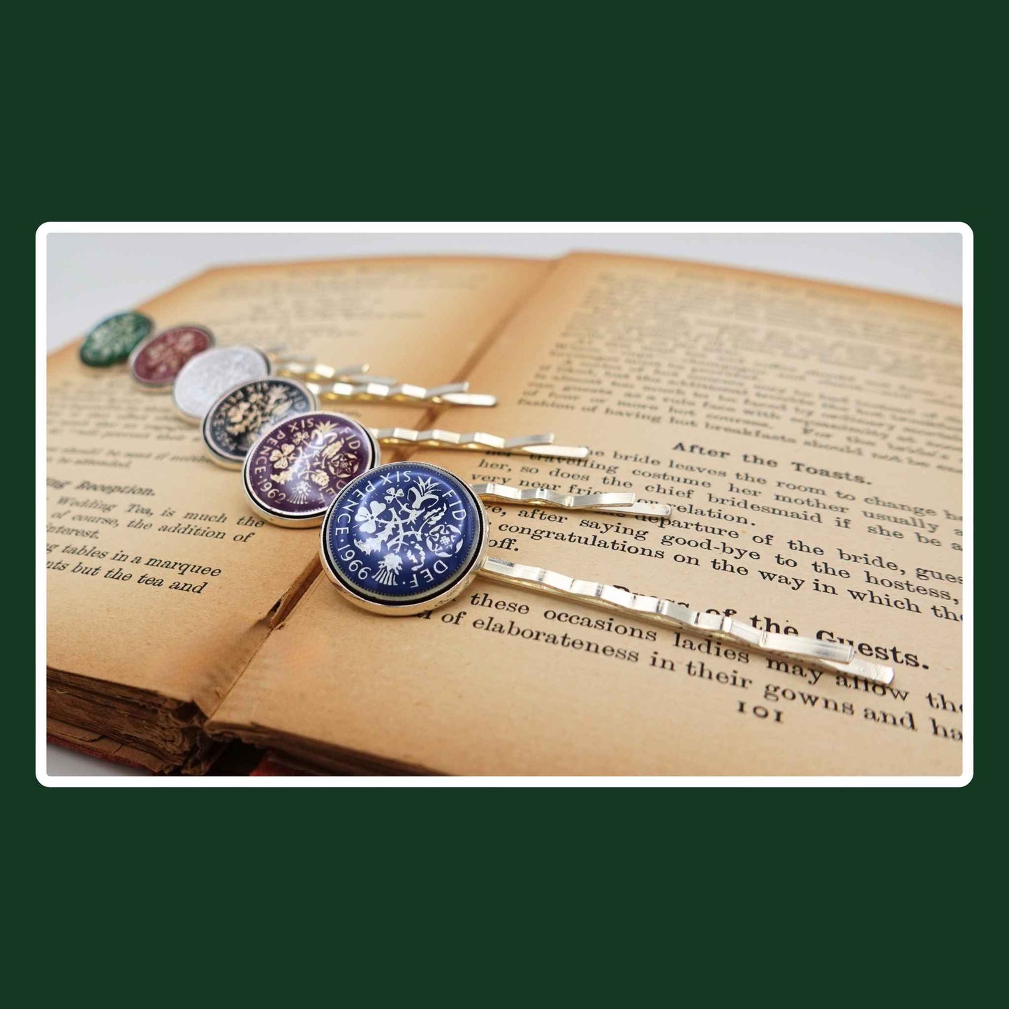 Silver plated hair slides with coloured enamel British sixpence coin design on a book