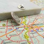 US Dime silver coin lapel pin on a map of Memphis, Tennessee