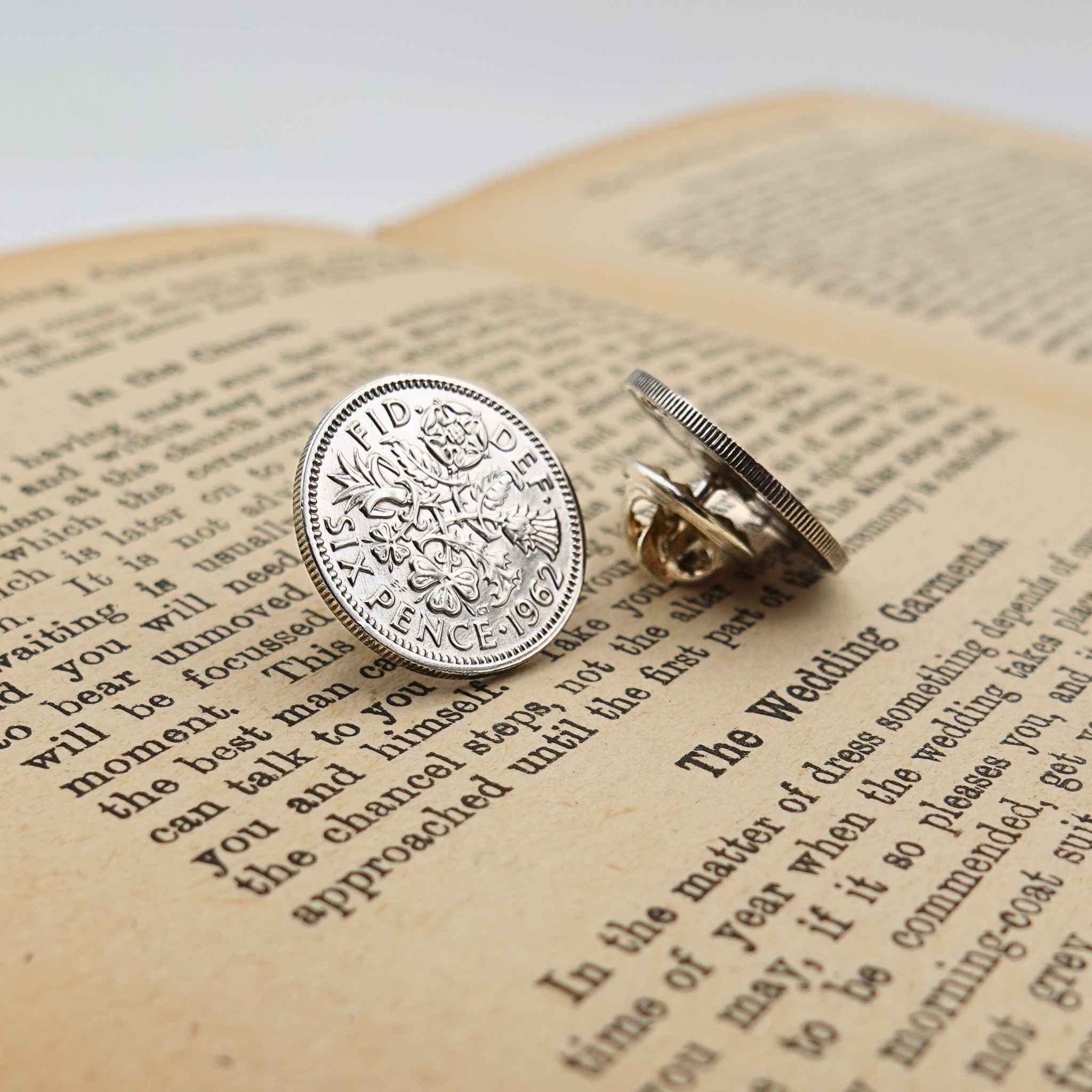 Two british sixpence coin lapel pins showing Queen Elizabeth 2nd mint design