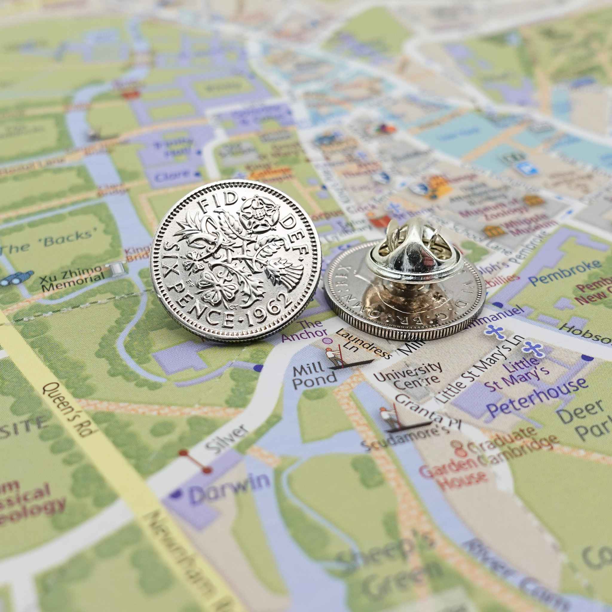 Two British sixpence coin lapel pins showing silver plated butterfly back