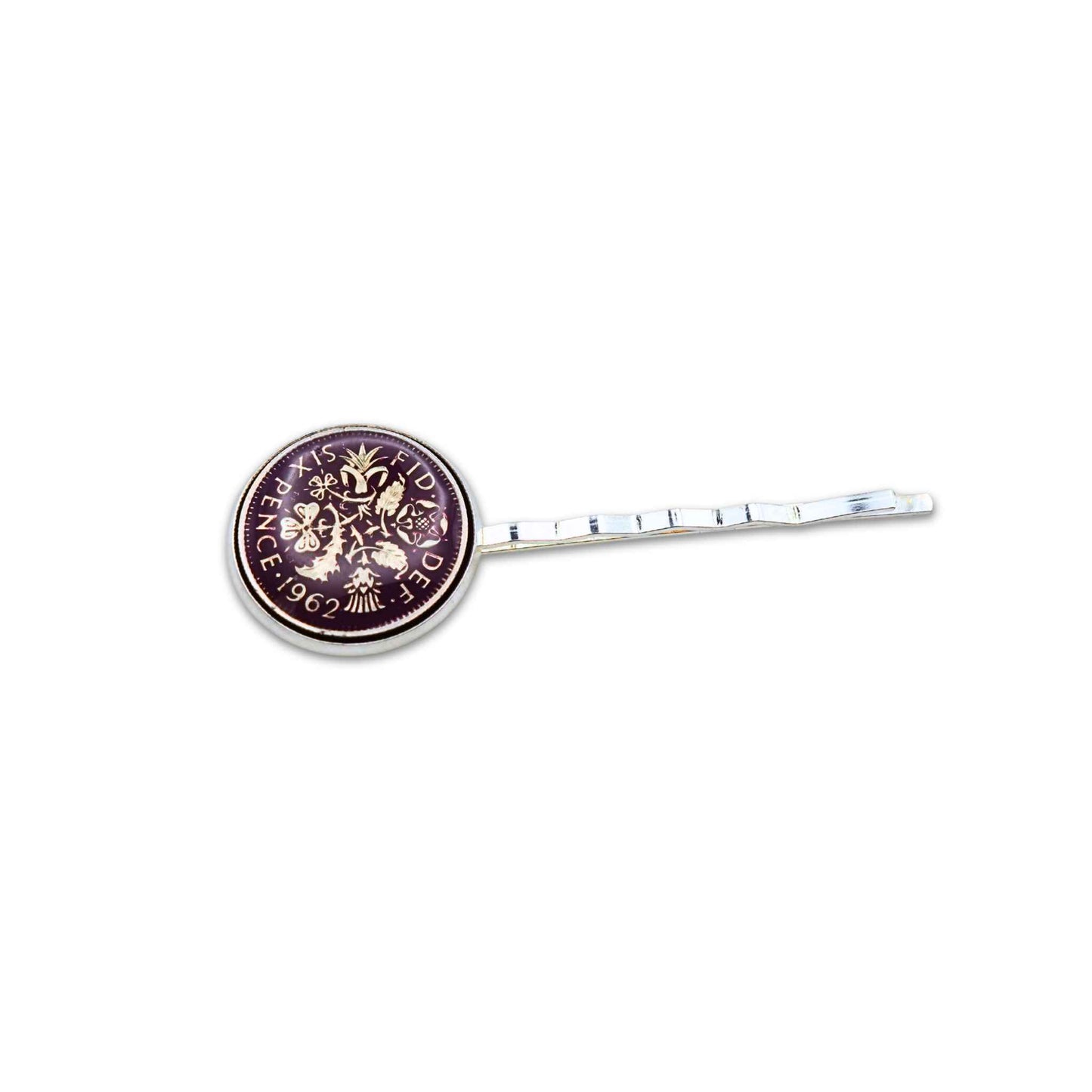 Silver plated hair slide with enamelled purple sixpence coin design on a white background