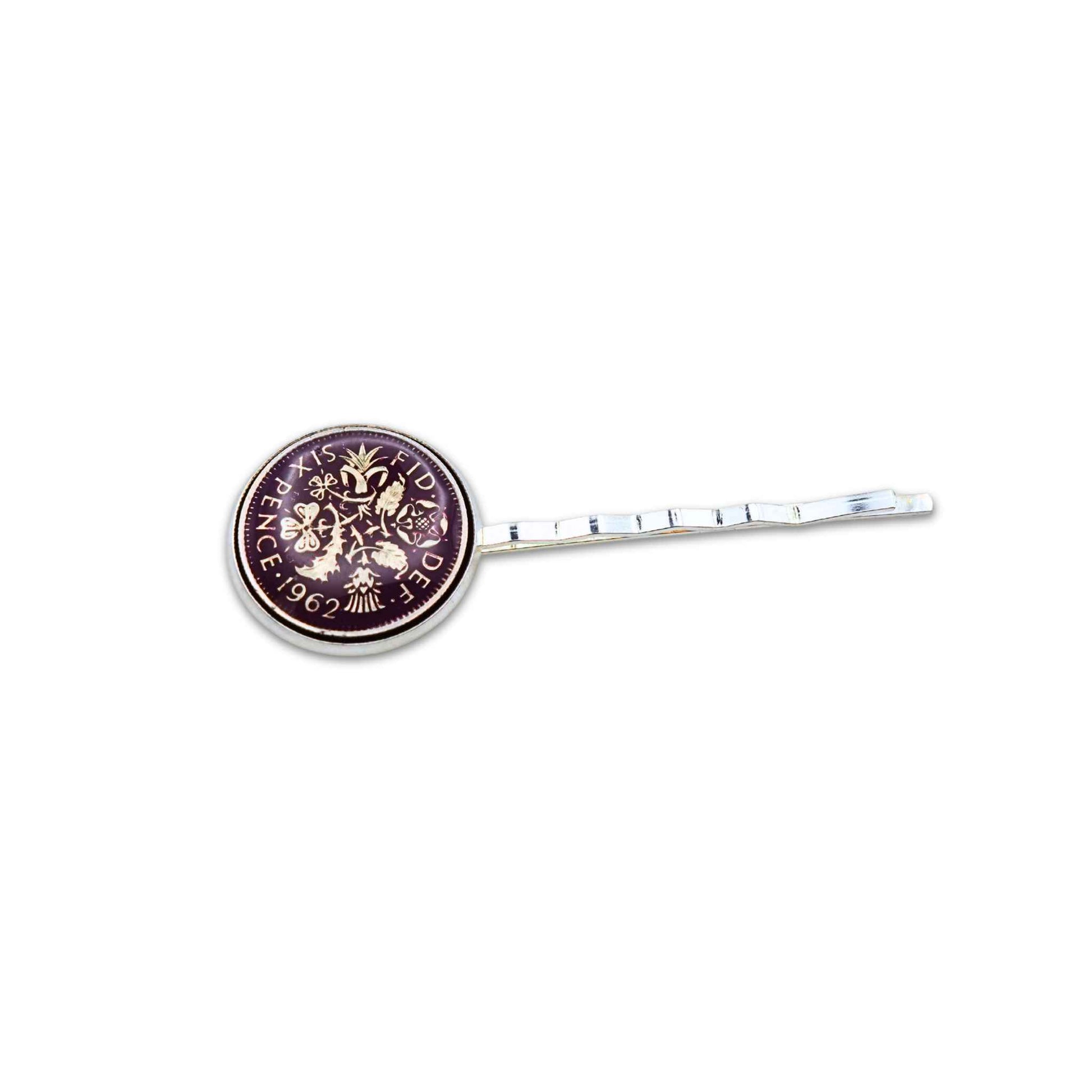 Silver plated hair slide with enamelled purple sixpence coin design on a white background