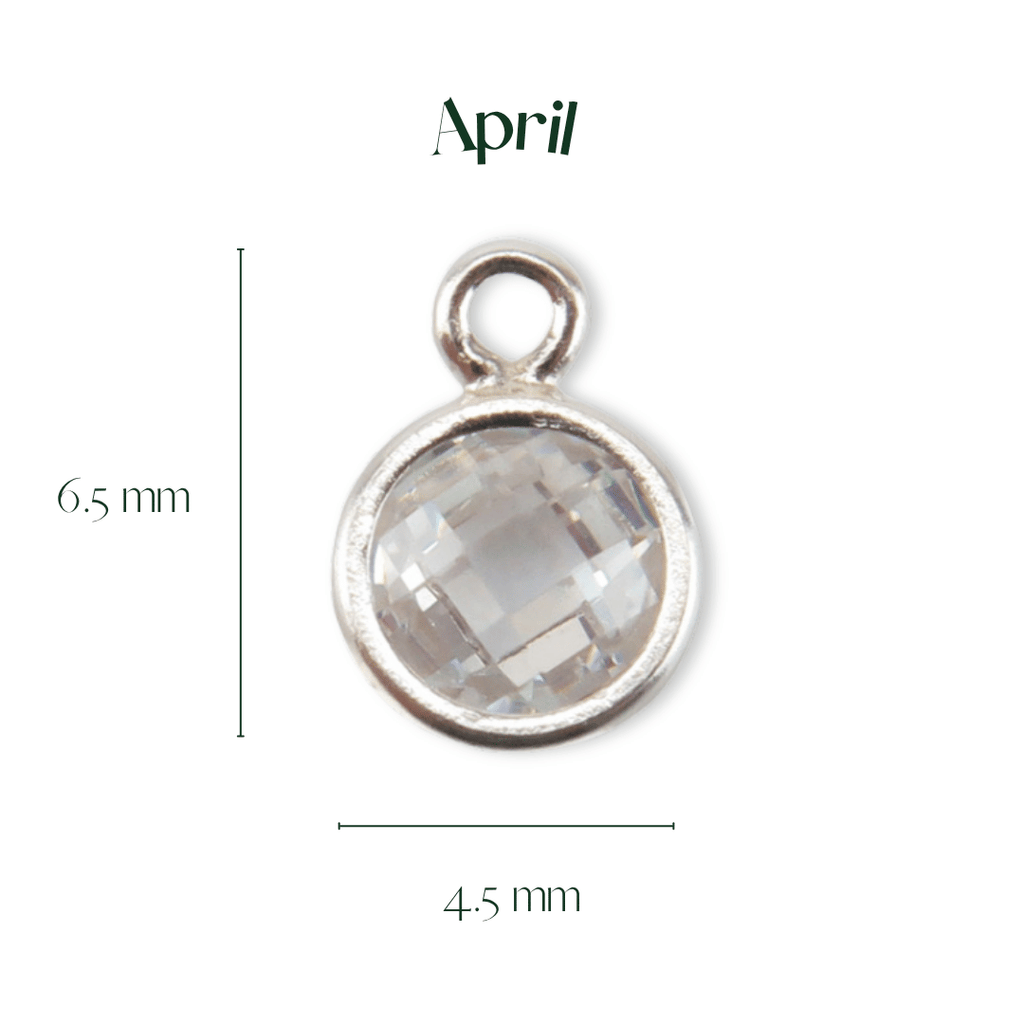 Silver pendant with a clear gemstone, labeled 'April', on a white background.