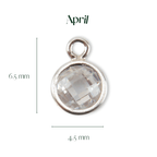 Silver pendant with a clear gemstone, labeled 'April', on a white background.