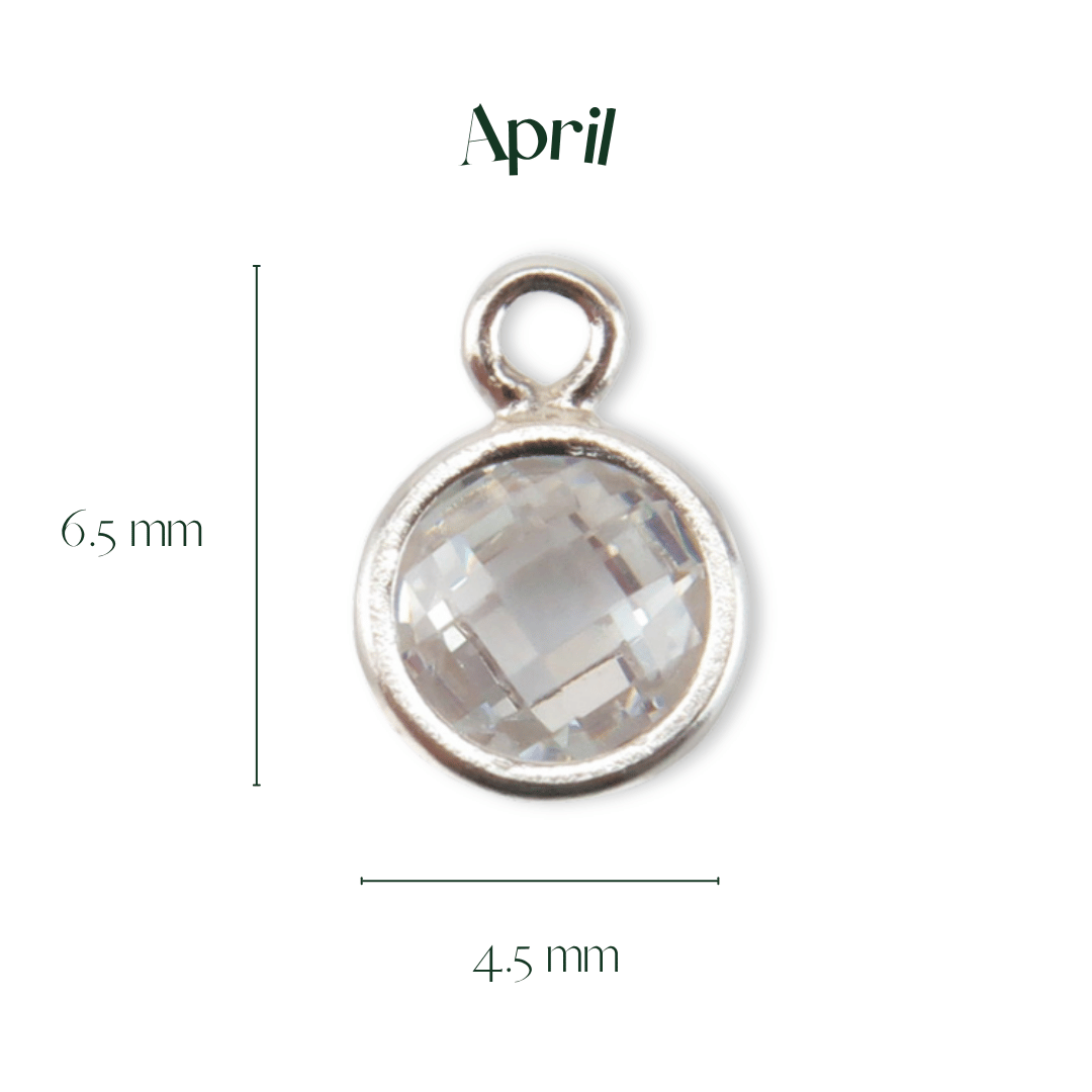 Silver pendant with a clear gemstone, labeled 'April', on a white background.