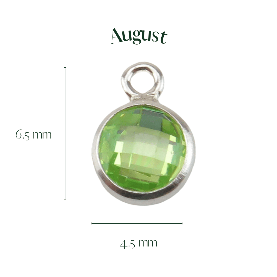 Green gemstone pendant with silver frame and 'August' text on a white background