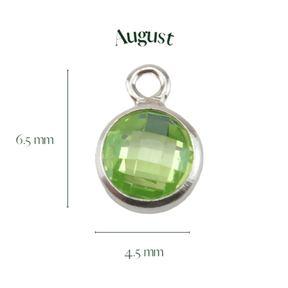 Green gemstone pendant with silver frame and 'August' text on a white background