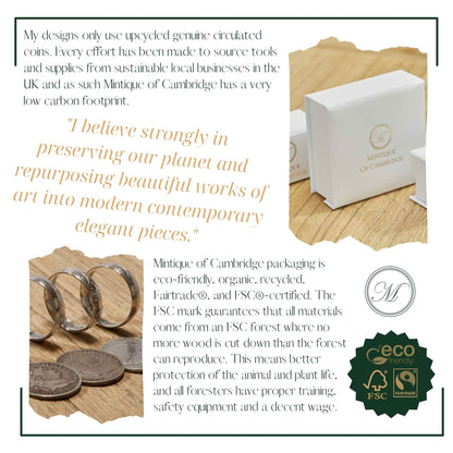 Mintique of Cambridge packaging with eco-friendly and FSC-certified branding, featuring coins and a box on a wooden surface.