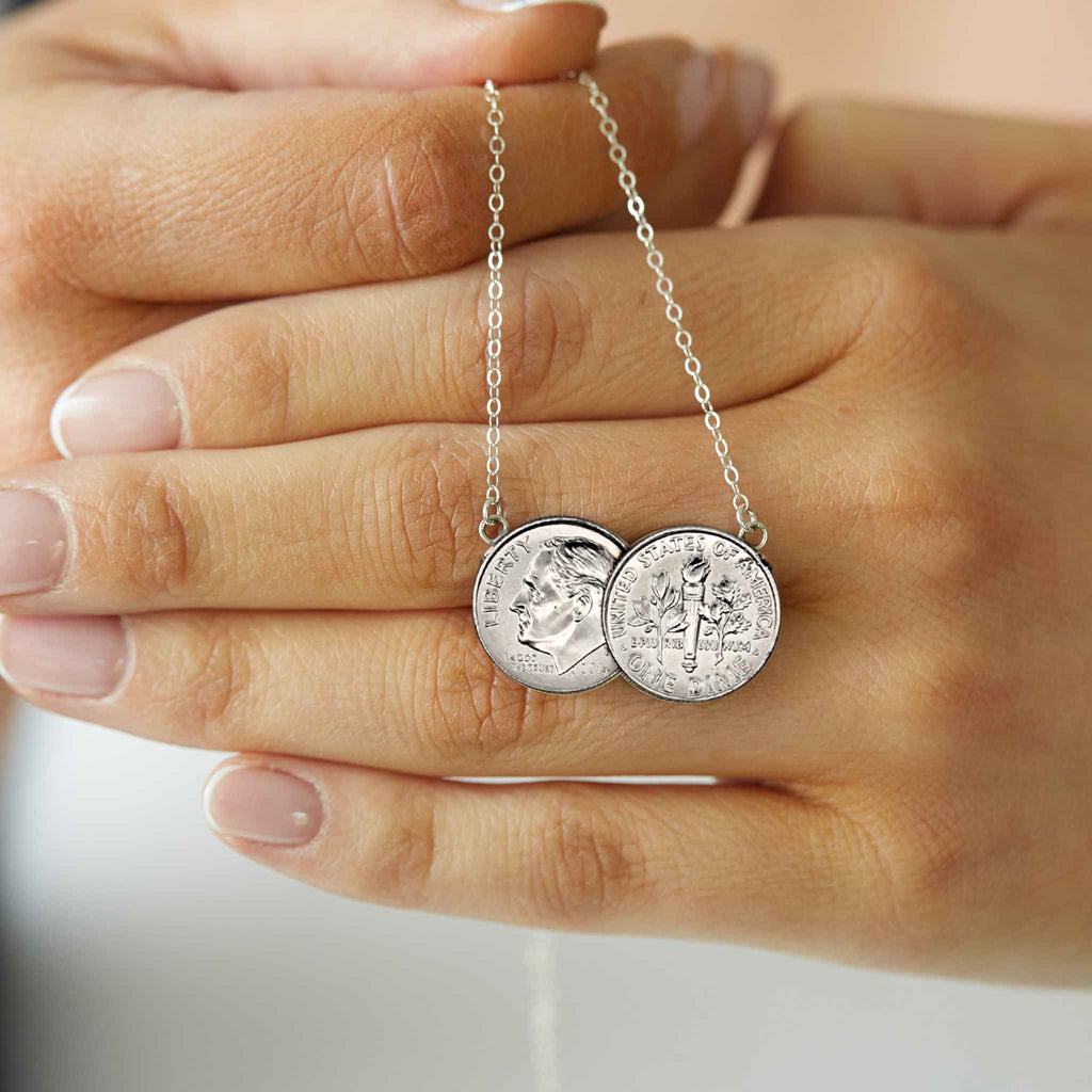 American Dime two coin necklace shiny silver held in hand