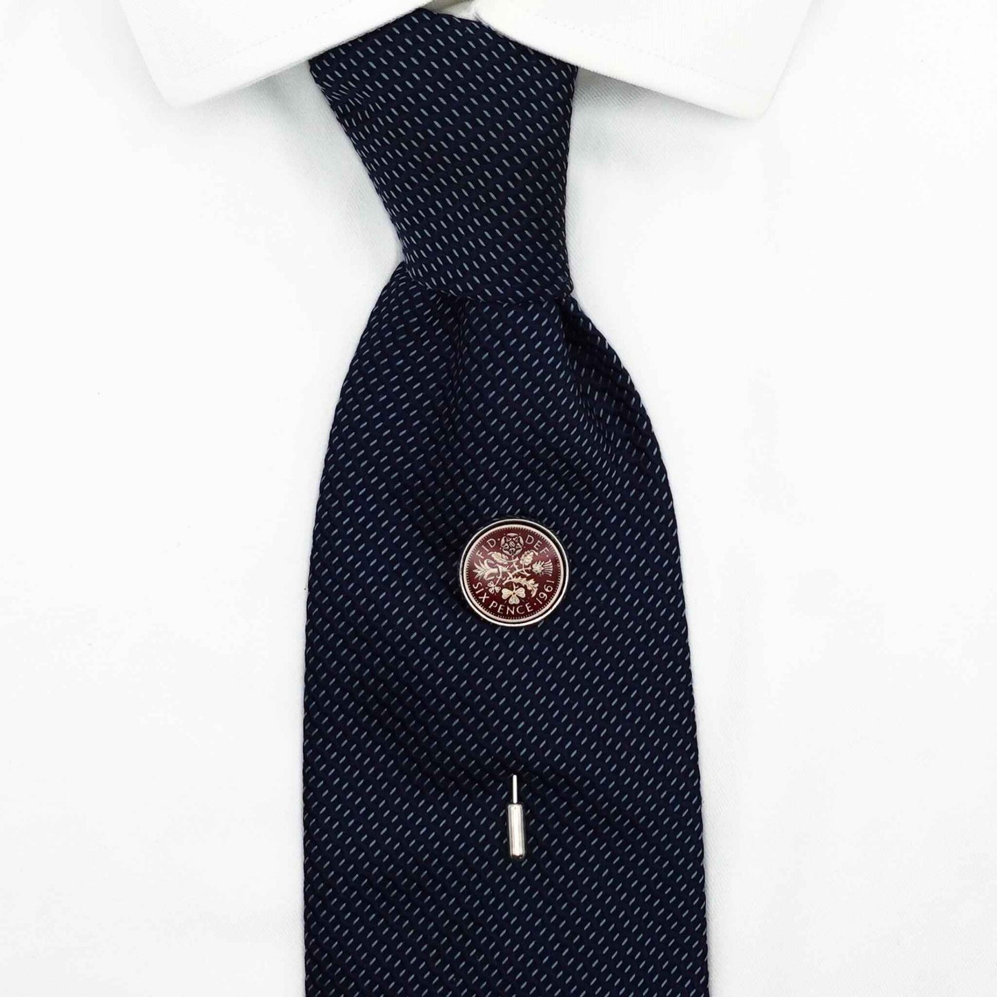 British sixpence coin red enamel silver plated tie pin on navy tie, white shirt in background