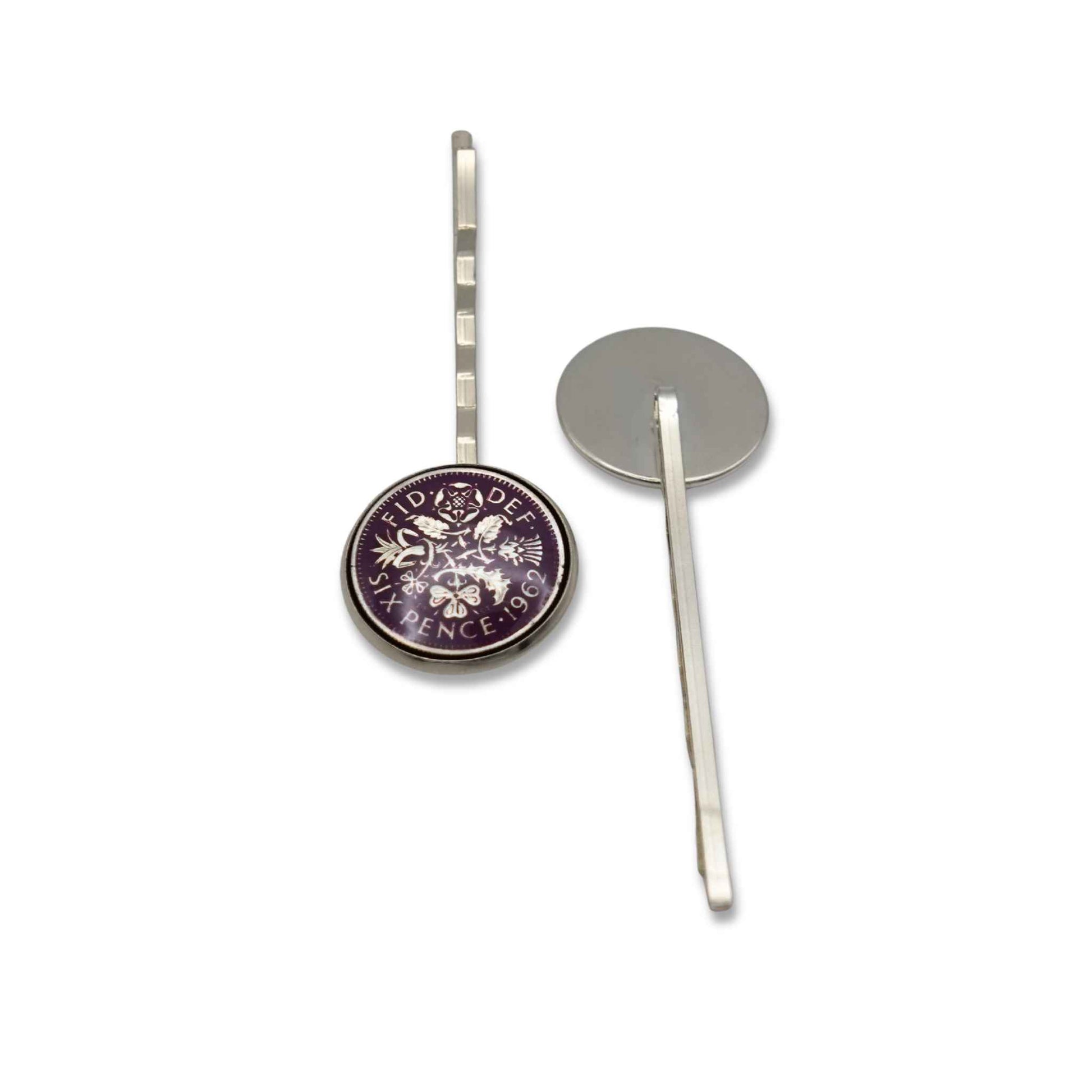 Silver hairpin with enamelled purple sixpence coin circular design on a white background