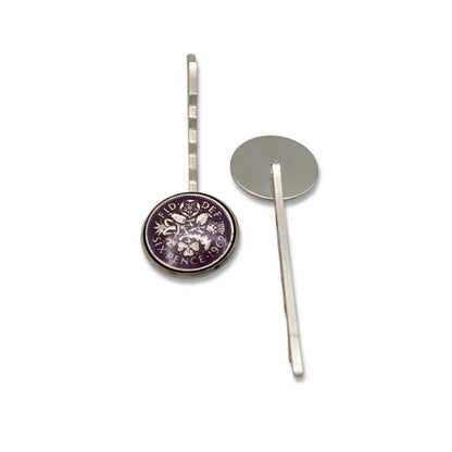 Silver hairpin with enamelled purple sixpence coin circular design on a white background
