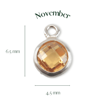 Silver pendant with a yellow gemstone labeled 'November' on a white background