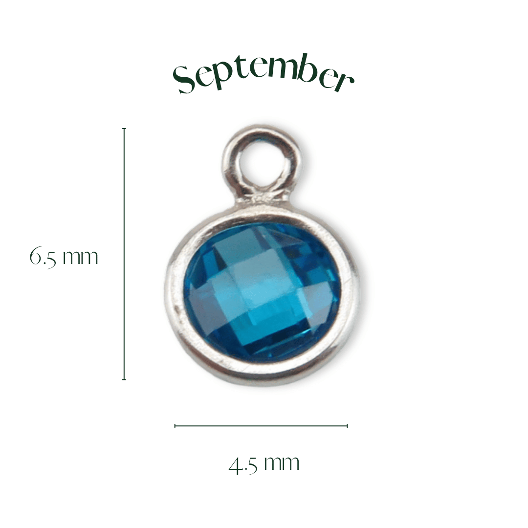 Blue gemstone pendant with silver frame and 'September' text on a white background