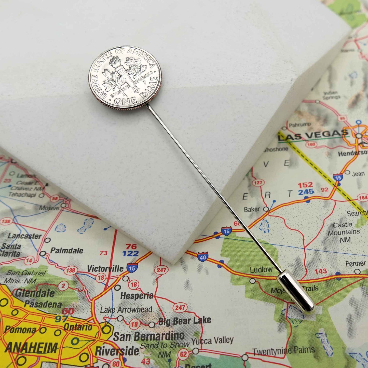 Silver US Dime coin lapel pin on a map of California with cities like Las Vegas, Anaheim, and San Bernardino.