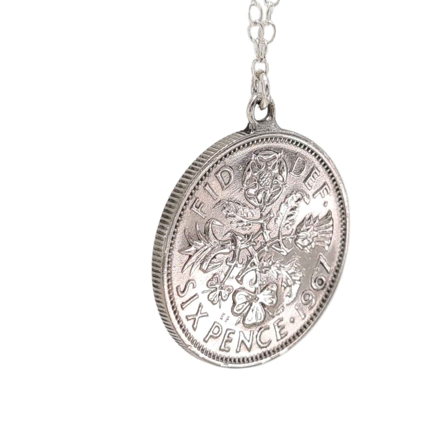 Silver British sixpence coin pendant necklace on a white background
