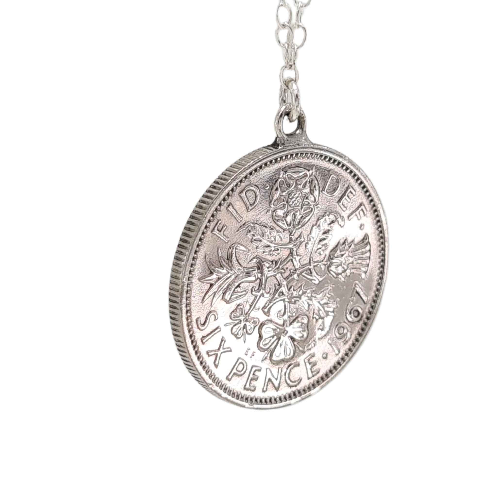 Silver British sixpence coin pendant necklace on a white background