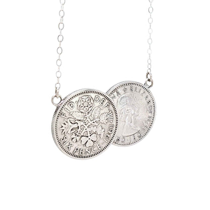 Silver double sixpence coin necklace on a white background