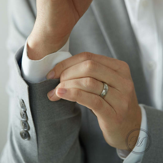 1820 shilling coin ring worn on ring finger with hands adjusting cuffs