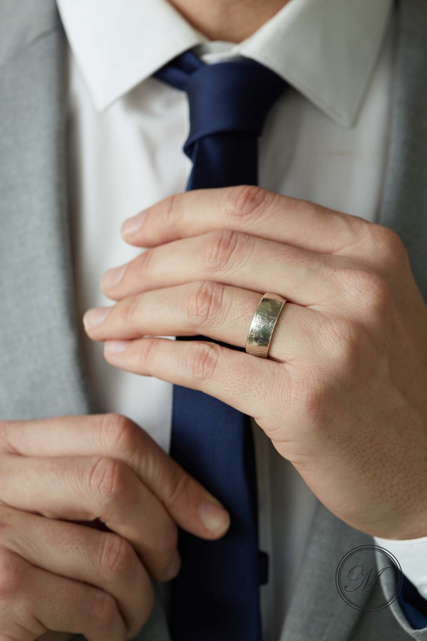 Florin coin ring worn on ring finger , adjusting tie