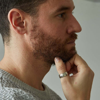 Half crown coin ring worn on thumb, hand under chin